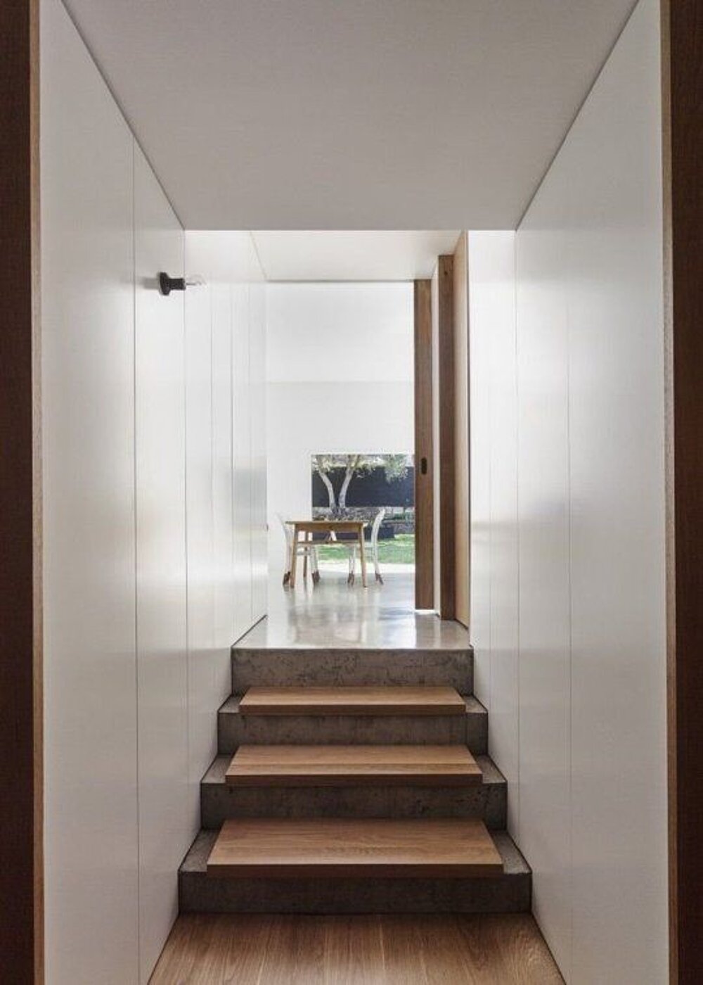 Staircase with timber treads overlooking the dining area