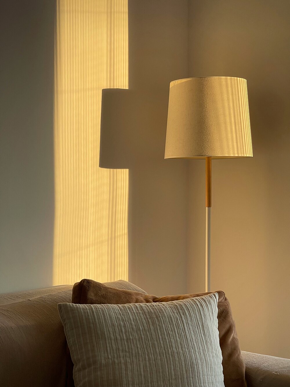 Floor lamp with warm light beside the sofa