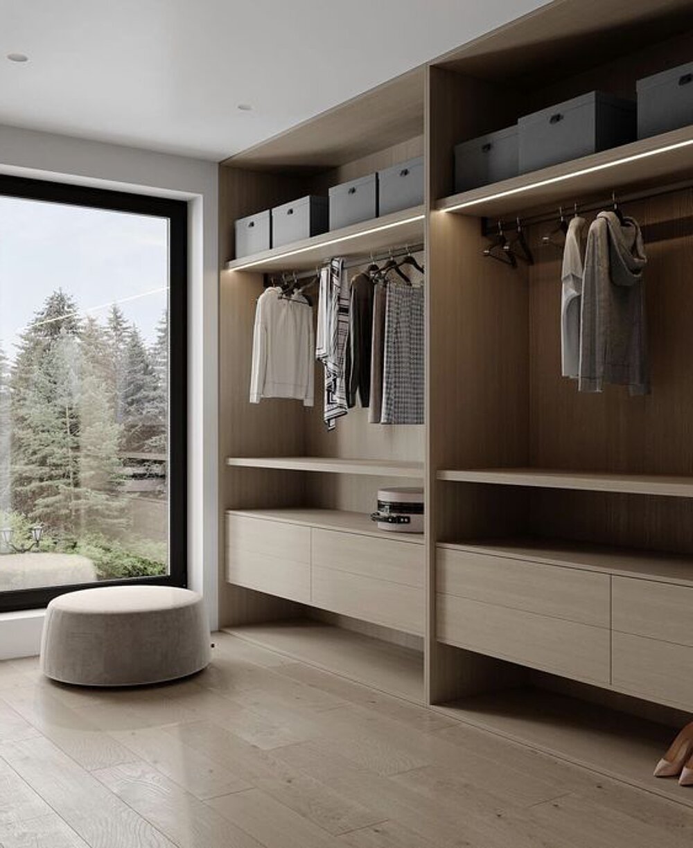 Walk-in wardrobe with bespoke built-in cabinetry and a window